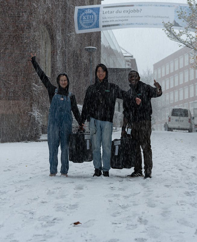 Students carrying Armada gear in the snow